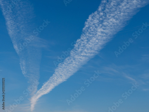 white trace of the plane in the blue sky