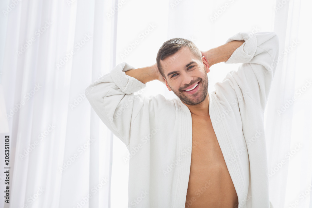 Happy smile. Delighted positive man being in a great mood while resting at home Happy smile. Delighted positive man being in a great mood while resting at home