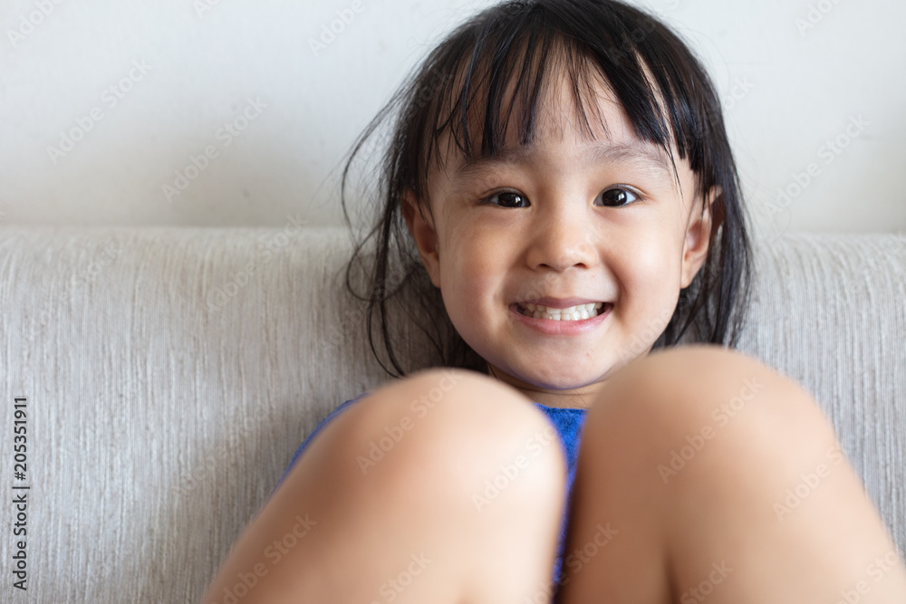 Asian Chinese little girl sitting on the sofa Asian Chinese little girl sitting on the sofa