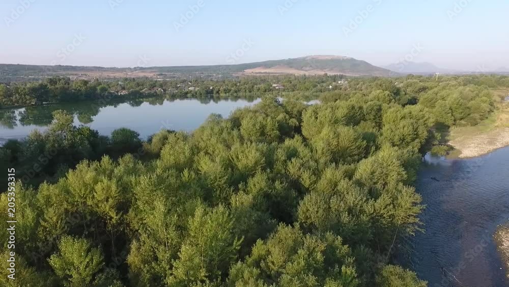 aerial typical Russian village with a Church on the shore of the lake and the river aerial typical Russian village with a Church on the shore of the lake and the river