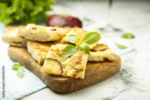 Onion pie with cheese and fresh basil