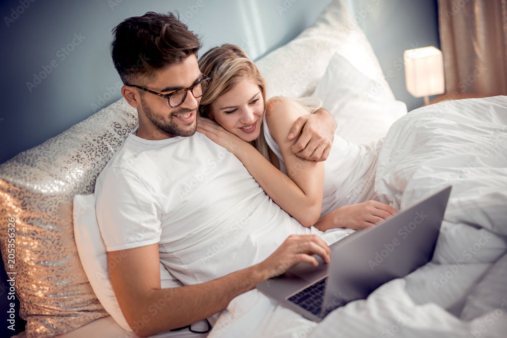 Beatiful lovers relaxing lying on their bed Beatiful lovers relaxing lying on their bed