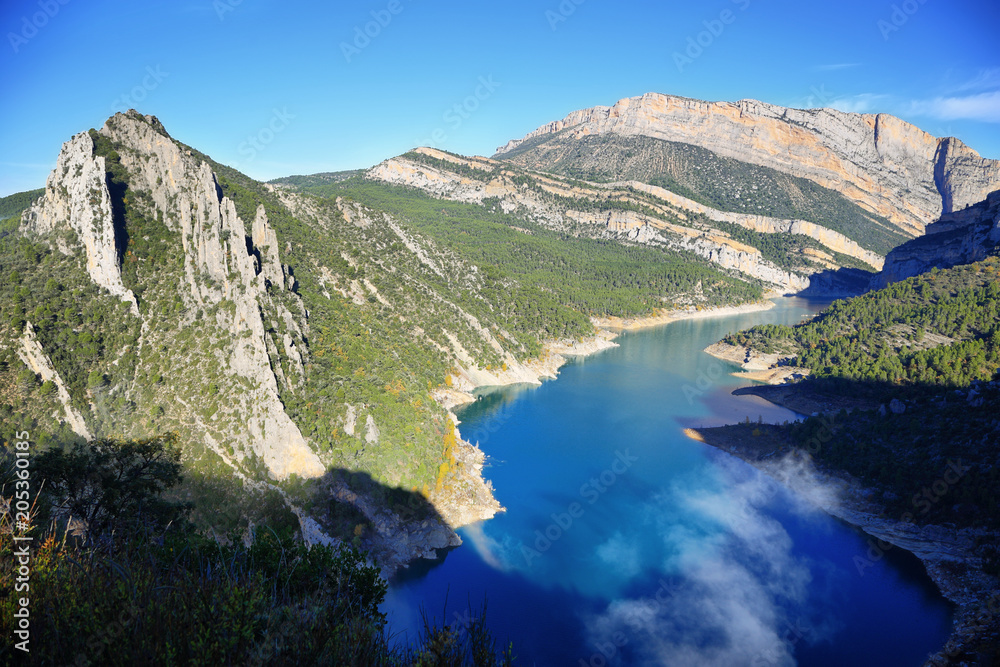 Spectacular cliff with a wooden walkway to be able to go down to a turquoise river. Montrebei Catalonia