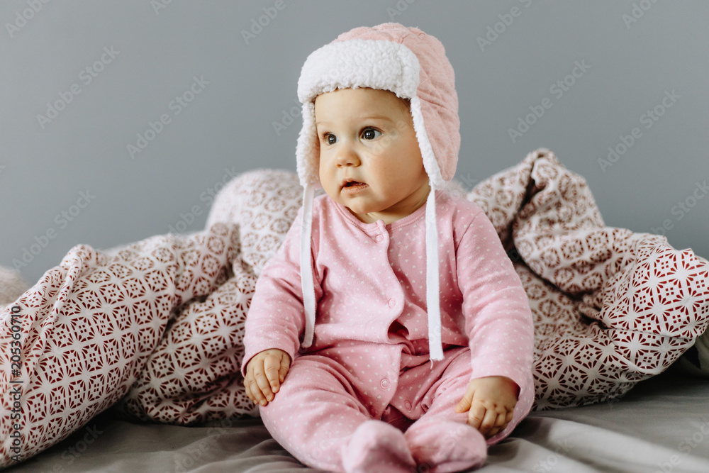 Portrait of a baby girl. The baby girl is sitting Portrait of a baby girl. The baby girl is sitting