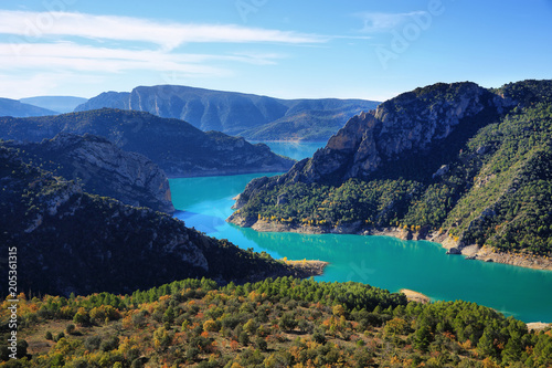 Spectacular cliff with a wooden walkway to be able to go down to a turquoise river. Montrebei Catalonia © estivillml