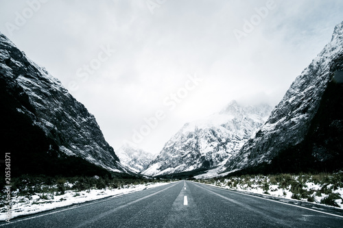 Beautiful scene of empty road to Milford sound after snow.
