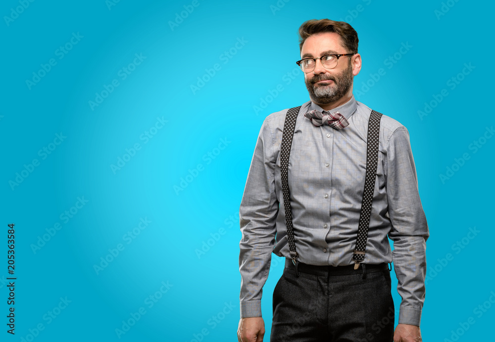 Middle age man, with beard and bow tie making funny face fooling Middle age man, with beard and bow tie making funny face fooling