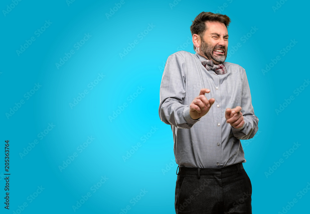 Middle age man, with beard and bow tie disgusted and angry, keeping hands in stop gesture, as a defense, shouting Middle age man, with beard and bow tie disgusted and angry, keeping hands in stop gesture, as a defense, shouting