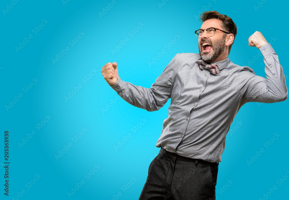 Middle age man, with beard and bow tie happy and excited celebrating victory expressing big success, power, energy and positive emotions. Celebrates new job joyful Middle age man, with beard and bow tie happy and excited celebrating victory expressing big success, power, energy and positive emotions. Celebrates new job joyful