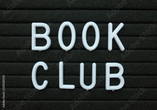 Фотография The words Book Club in white plastic letters on a black letter board as a remind