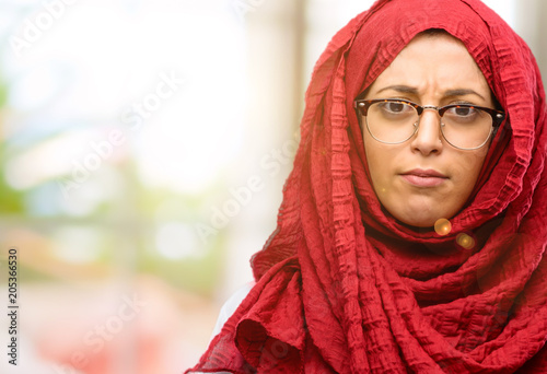 Young arab woman wearing hijab irritated and angry expressing negative emotion, annoyed with someone