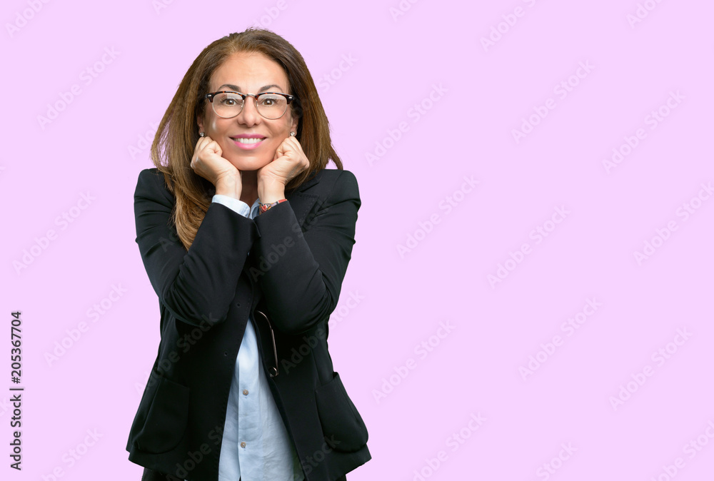 Middle age business woman happy and surprised cheering expressing wow gesture Middle age business woman happy and surprised cheering expressing wow gesture