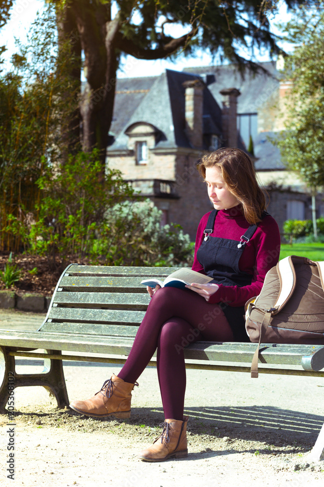 girl at the park reading a book girl at the park reading a book