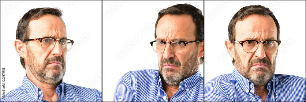 Middle age handsome man closeup with crossed arms confident and happy with a big natural smile laughing Middle age handsome man closeup with crossed arms confident and happy with a big natural smile laughing