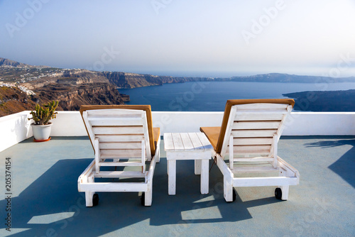 Relaxing benches to watch sunset in Santorini Island, Greece. View toward Caldera sea. © iamjiere