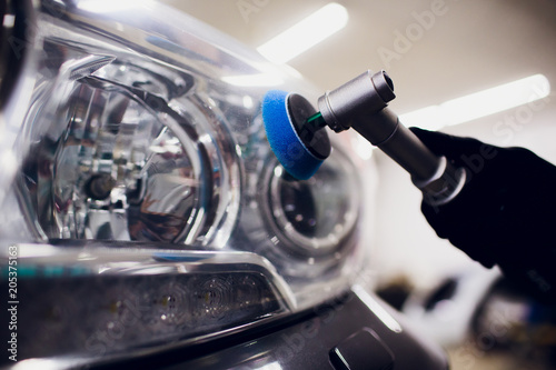 Obraz na plátne Car polish wax worker hands holding polisher and polish car detailing or valetin