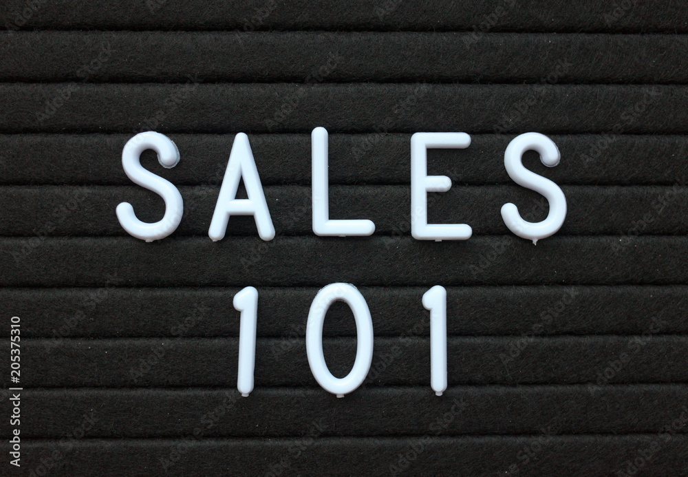The words Sales 101 in white plastic letters on a black letter board as an introduction to the methods used to sell products and services The words Sales 101 in white plastic letters on a black letter board as an introduction to the methods used to sell products and services