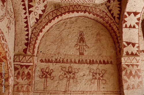 Murals in ancient Christian cave church with red geometrical ornaments ,Cappadocia,Turkey