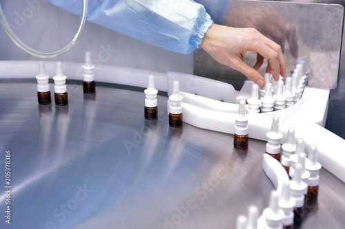 The production line of the medicine. Filling interferon in bottl