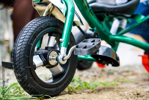 Wheel of green children s tricycle close