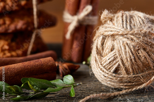 Close-up still-life of cinnamon, star anise and ball of yarn on wooden background , shallow depth of field