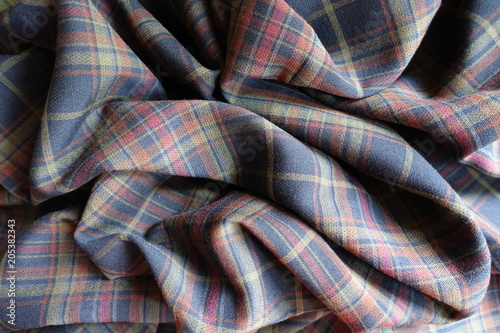 Wrinkled thick plaid fabric in subdued colors