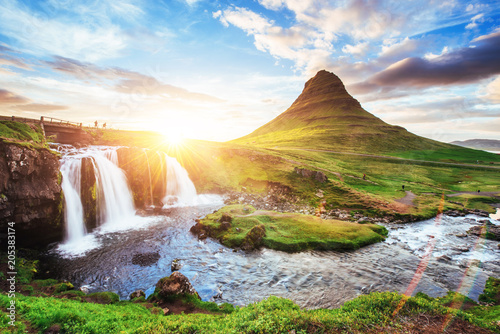 The picturesque sunset over landscapes and waterfalls. Kirkjufell mountain, Iceland