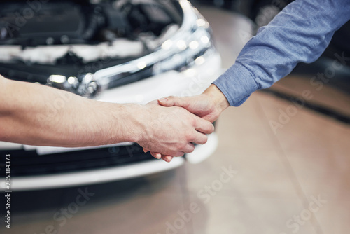 husband car mechanic and woman customer make an agreement on the repair of the car