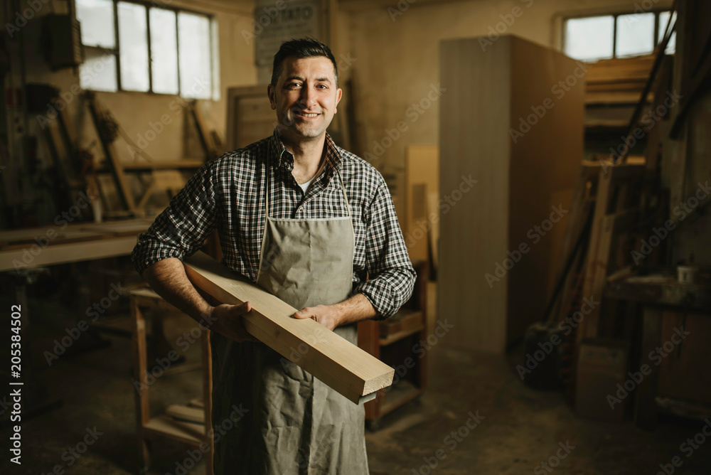 Image of mature carpenter in the workshop Image of mature carpenter in the workshop