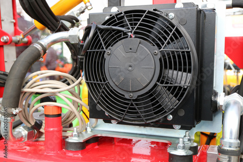 powerful fan is mounted on a red metallic base.