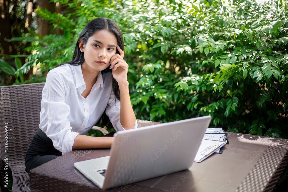 Portrait of smiling pretty young business woman sitting on workplace Portrait of smiling pretty young business woman sitting on workplace