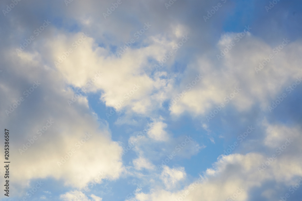 movement of white clouds against a blue sky.
