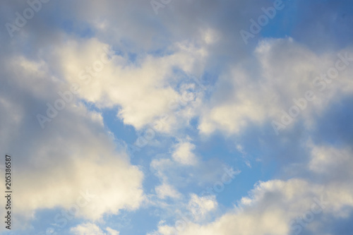 movement of white clouds against a blue sky.