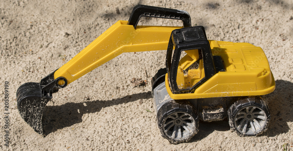 A small and sand-drenched excavator. A small and sand-drenched excavator.