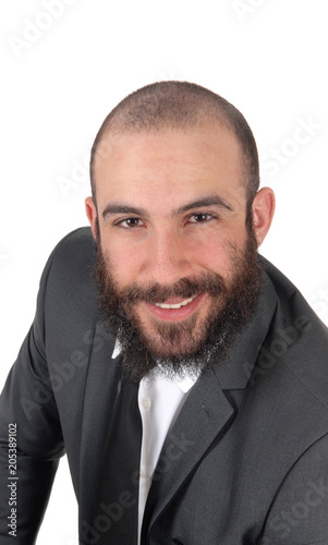 Business man sitting, bending forward, smiling