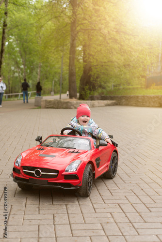 A child is riding an electric car