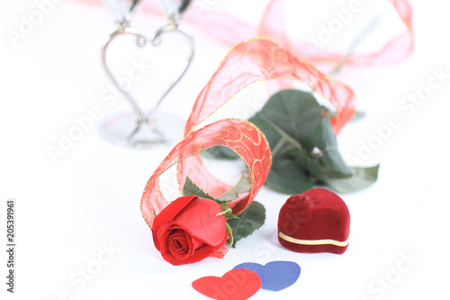 rose and a box with a ring on a Valentine's day card .photo with copy space