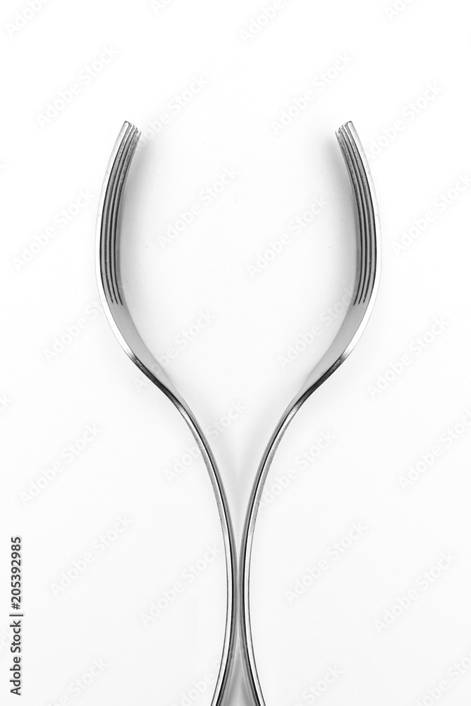 Two forks in a shape to resemble a wine glass. Vertical Food and Drink concept Two forks in a shape to resemble a wine glass. Vertical Food and Drink concept
