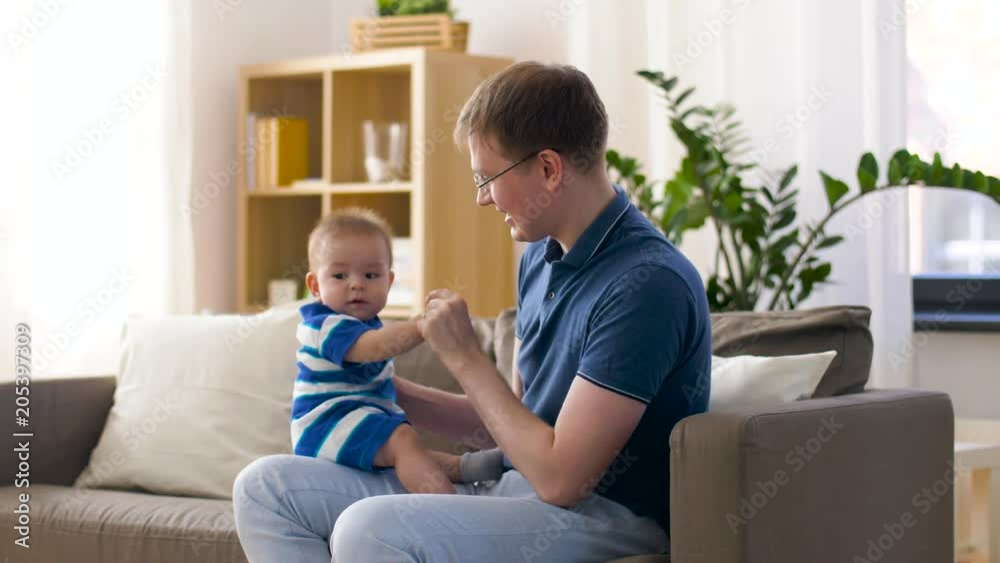 family, fatherhood and childhood concept - happy baby boy with father at home family, fatherhood and childhood concept - happy baby boy with father at home