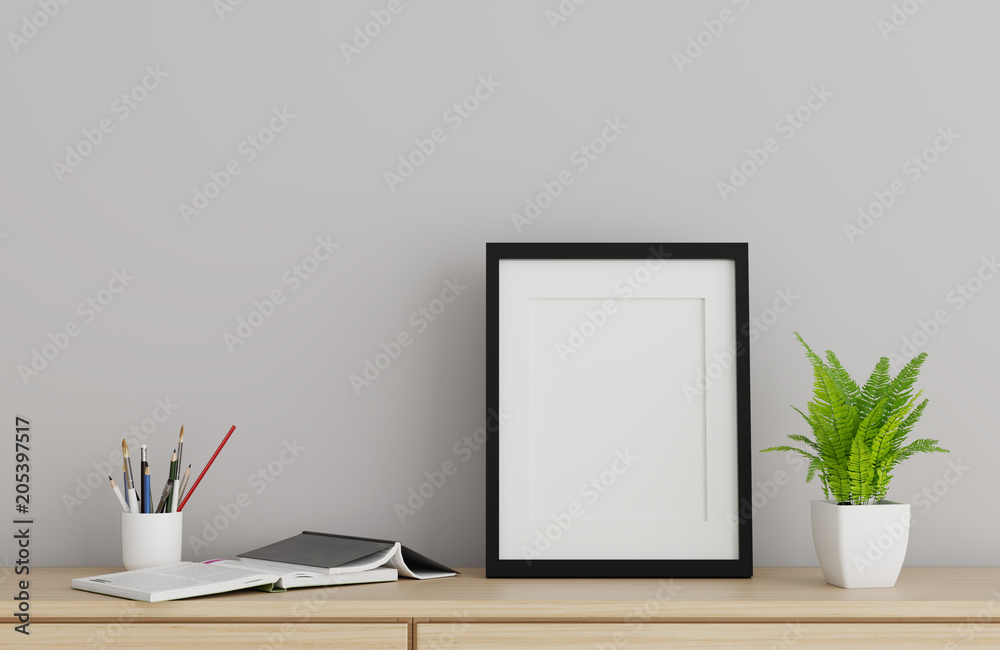 Blank black picture frame template for place image or text inside with a little tree on wood table. Blank black picture frame template for place image or text inside with a little tree on wood table.