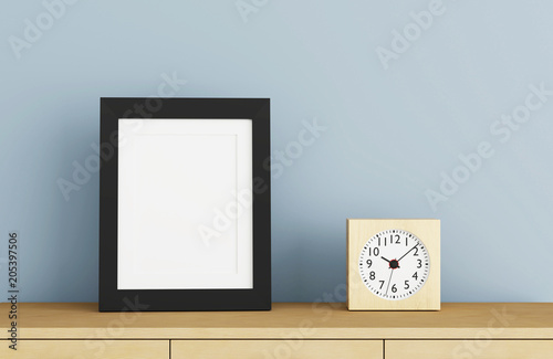 Blank black picture frame template for place image or text inside with a little tree on wood table.