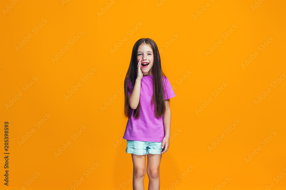 Isolated on orange young casual teen girl shouting at studio Isolated on orange young casual teen girl shouting at studio