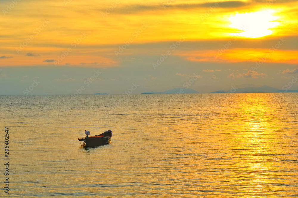 Vacation time concept, A boat going and parking in the sea with sunset time or golden time and cloud in the background.