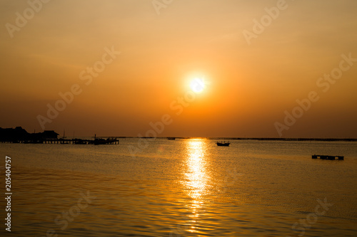 Fishing boat at sunset and Oyster farm. Chonburi Thailand.