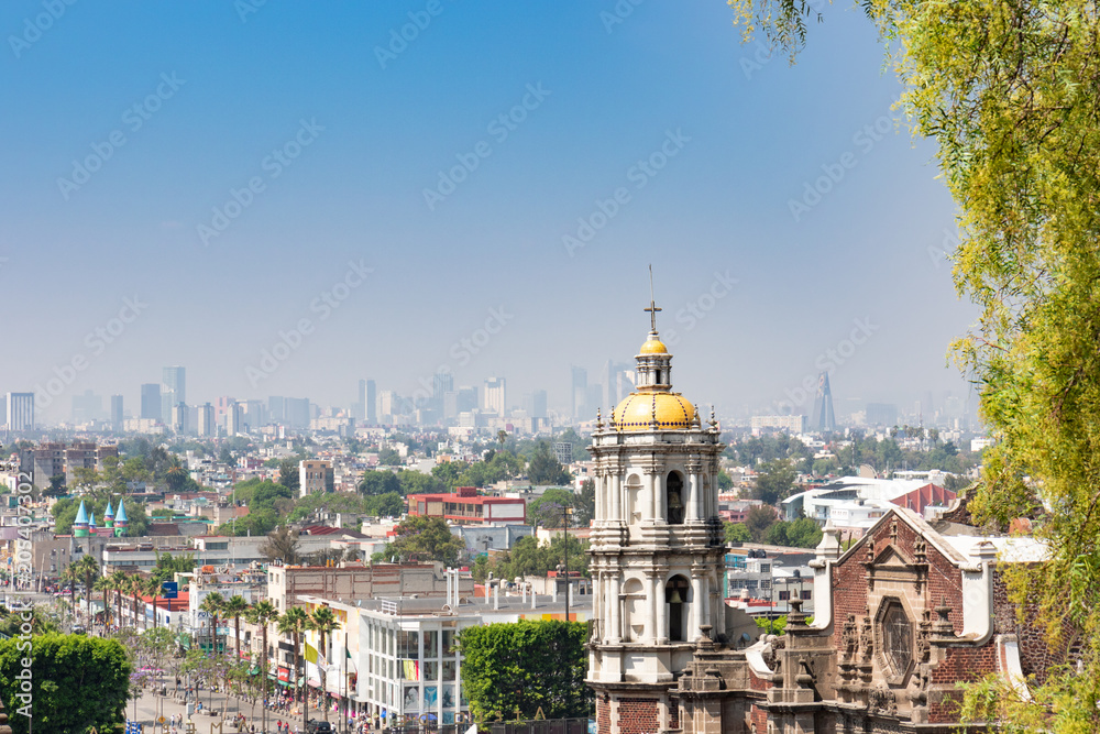 Shrine of Our Lady of Guadalupe, view of the old basilica from the eighteenth century. In the distance, the panorama of Mexico City