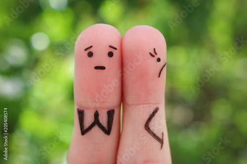 Fingers art of displeased couple. Woman was offended, man asks her forgiveness.