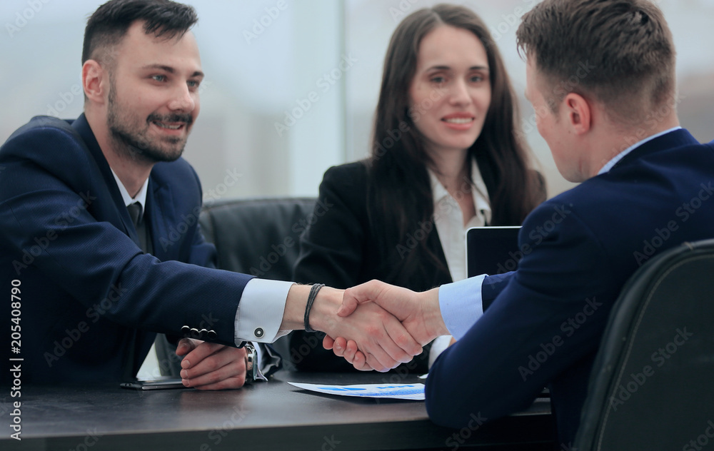handshake financial partners sitting at the table handshake financial partners sitting at the table