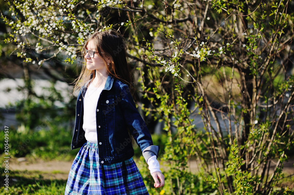 Kid girl in blooming apple garden Kid girl in blooming apple garden