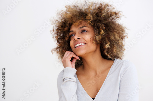 Close up beautiful black young woman smiling against white wall