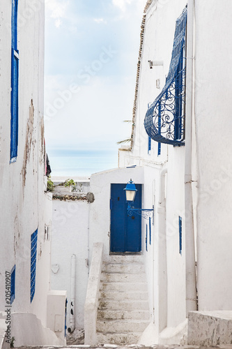 blue door and windows in white Arab courtyard Tunisia © ksenija1803z